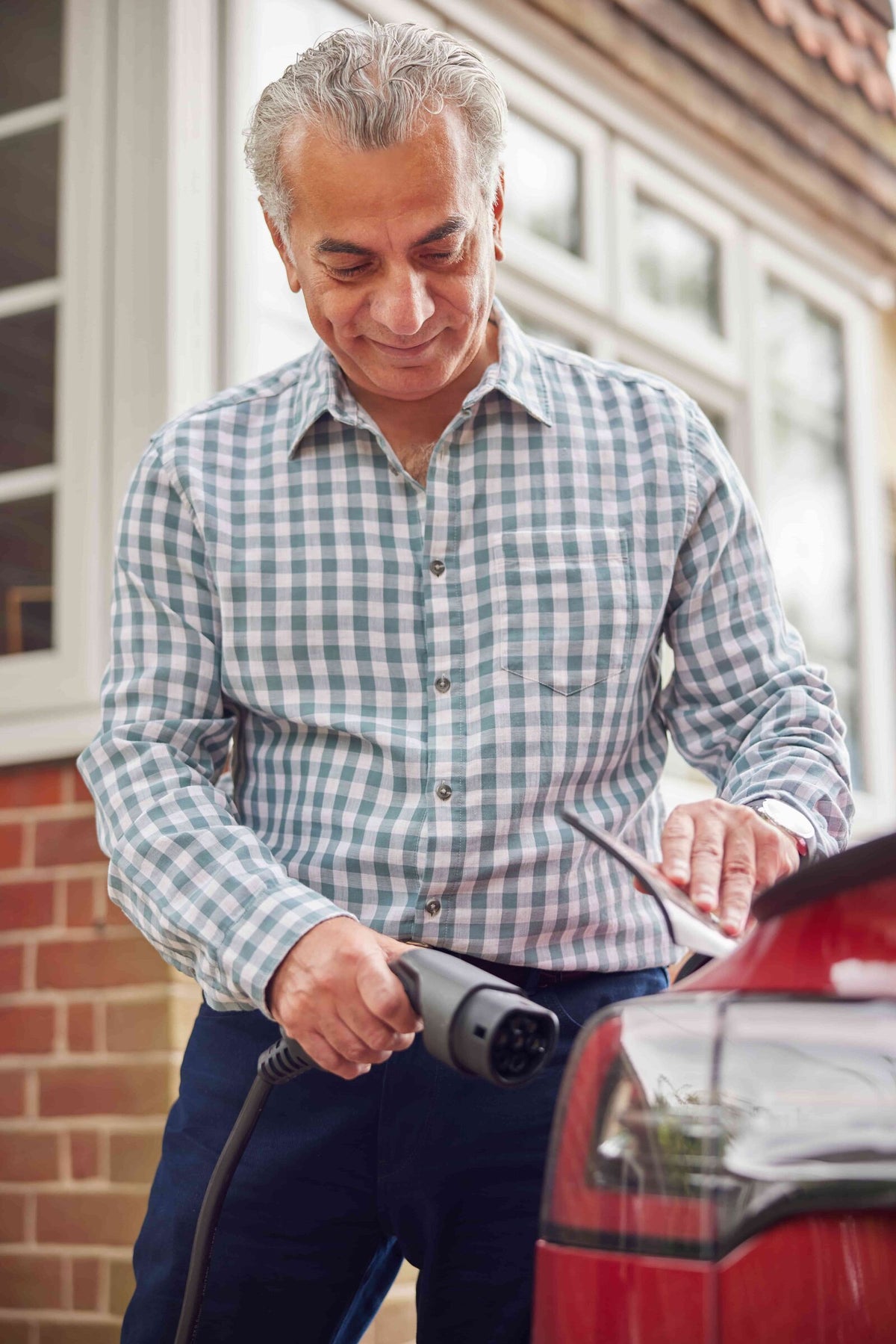 Person charging EV at home