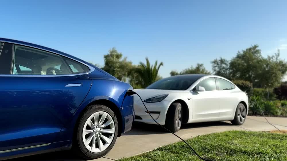 Two electric cars parked in a driveway
